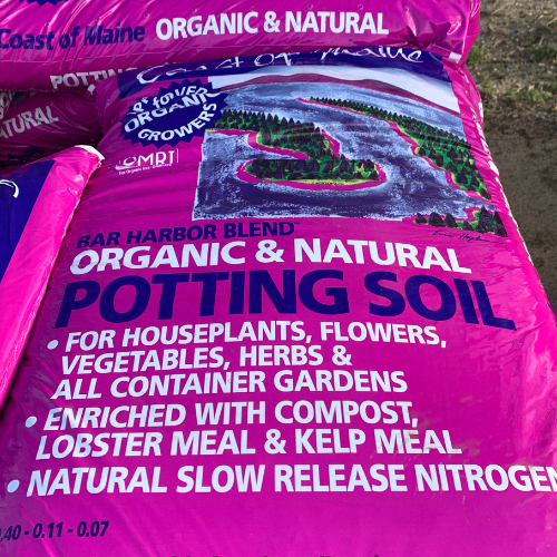 Purple bag of Bar Harbor Blend Organic & Natural Potting Soil with text detailing its use for houseplants and gardens. Image of a coastal landscape.