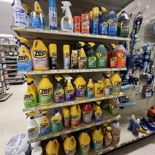 Shelves in a store display an array of colorful Zep cleaning products, including sprays and bottles, creating a vibrant and organized presentation.