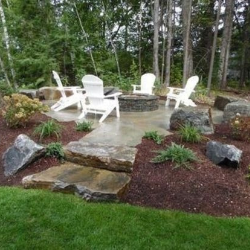 Adirondack chairs surrounding a fire pit outside of Lucy Hardware.